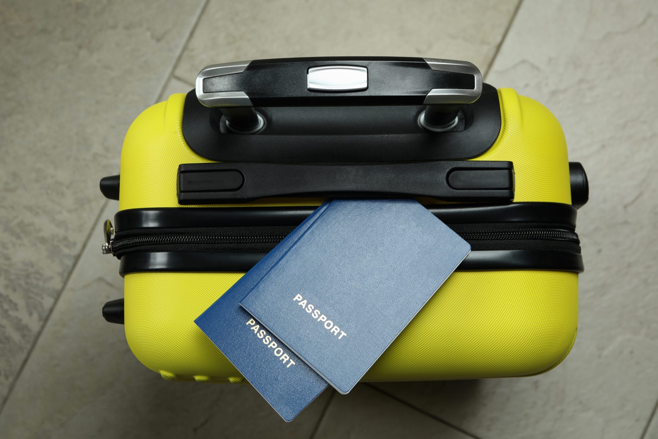 Top view of a yellow travel bag with passports.